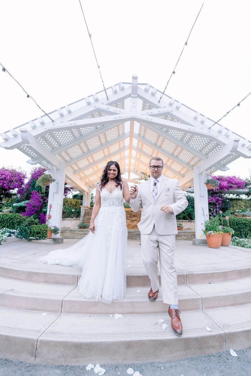 Newlyweds walking down the gazebo steps after their ceremony